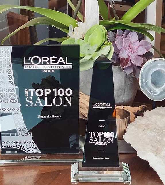 L'Oréal Top 100 Salon awards showcase with plants and decorative stones.